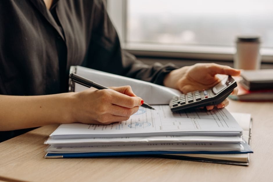 U.S. Treasury and savings bond paperwork beside a calculator on a desk